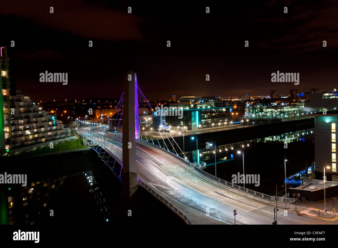 The floodlit 'squinty bridge' crossing the Clyde in Glasgow at night Stock Photo