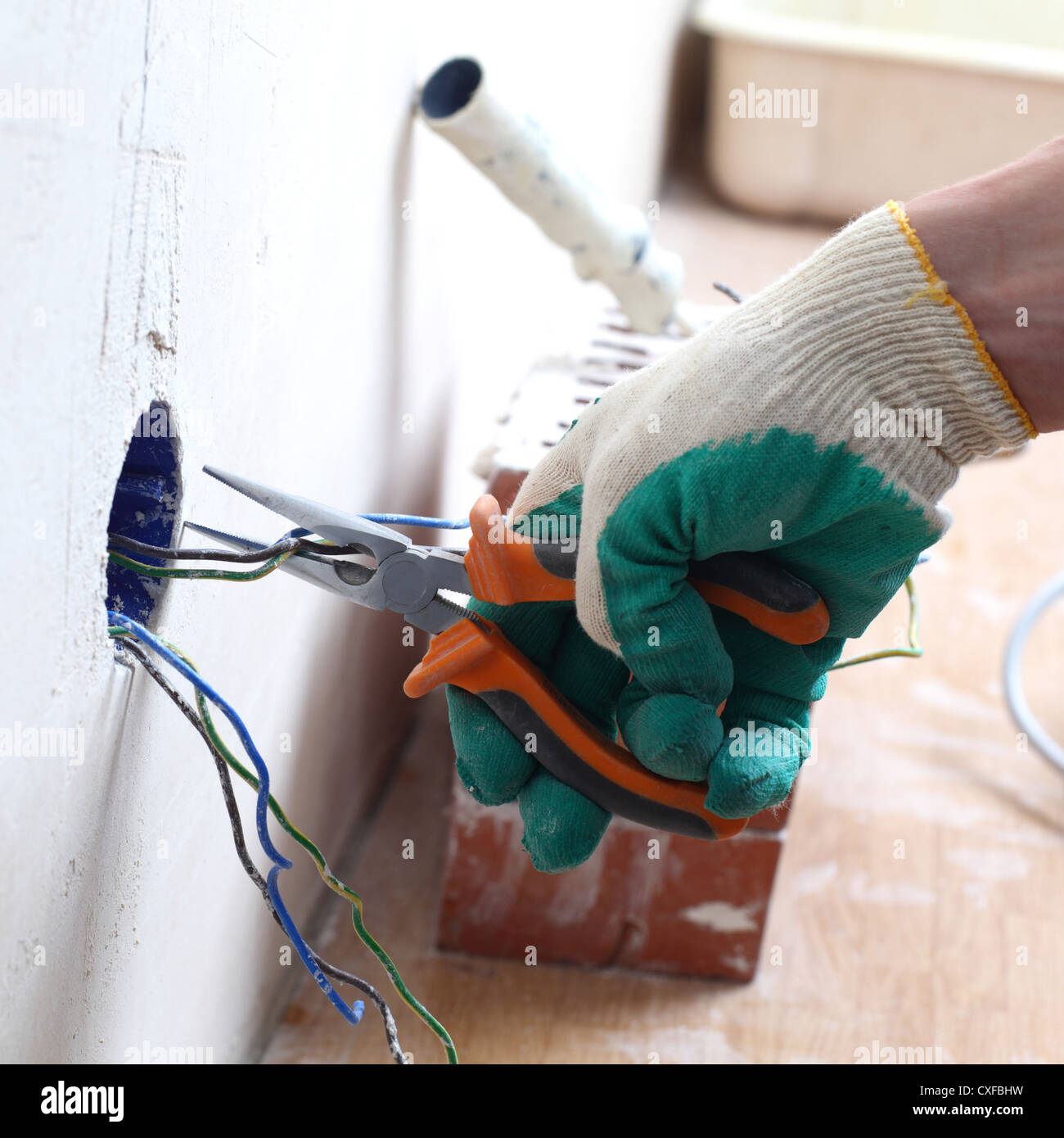 worker puts the wires in the wall Stock Photo Alamy