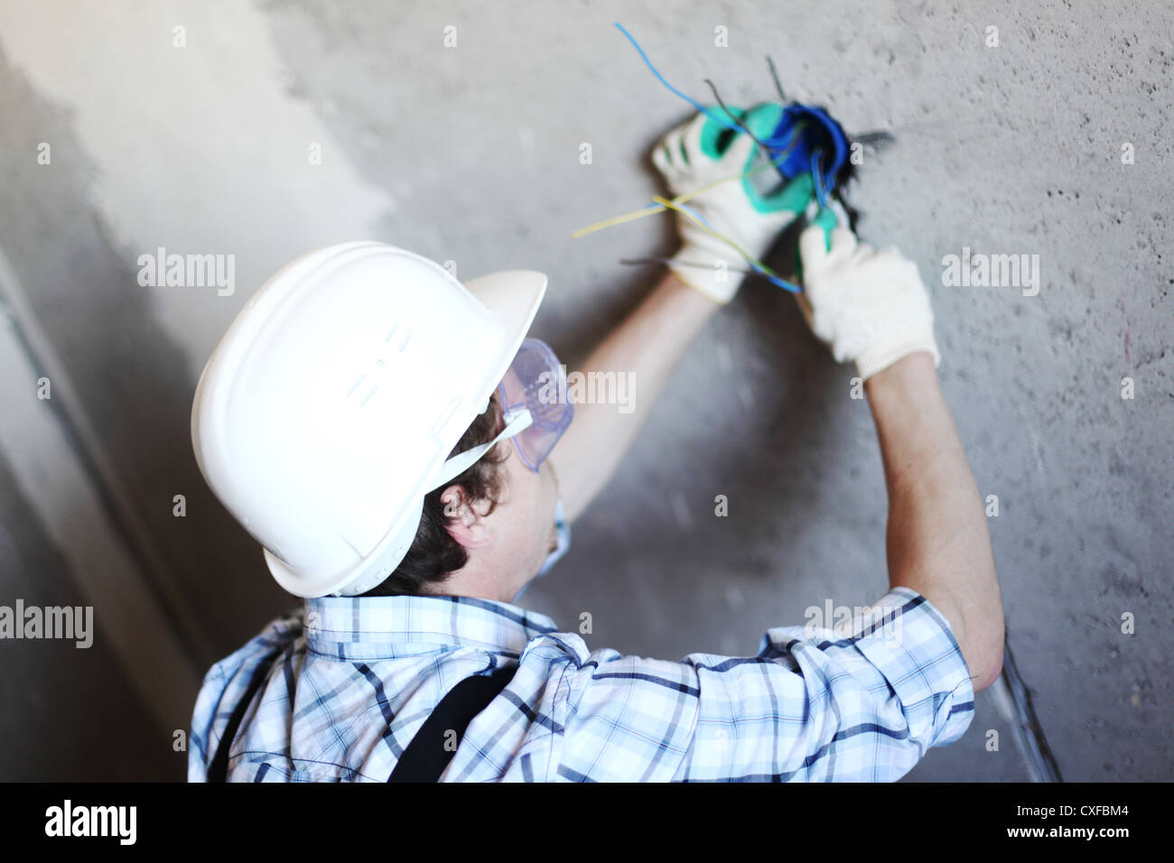 worker puts the wires in the wall Stock Photo Alamy