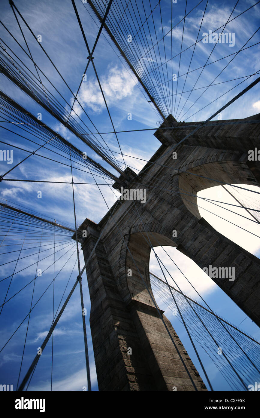 Detail of the Brooklyn Bridge with a blue sky and fine clouds Stock Photo