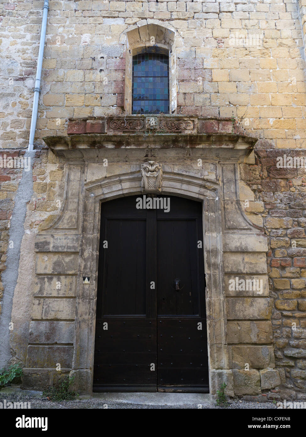 An ancient stone doorway in the medieval old town streets of Fanjeaux in Aude, Languedoc, France Stock Photo