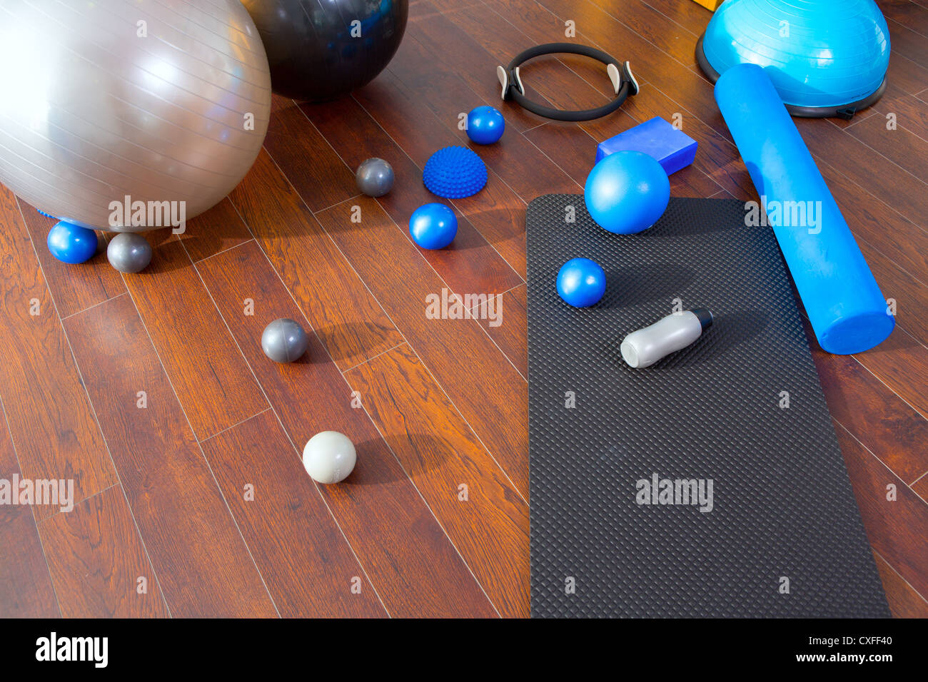 Aerobic Pilates stuff like mat balls roller magic ring rubber bands on wooden floor Stock Photo