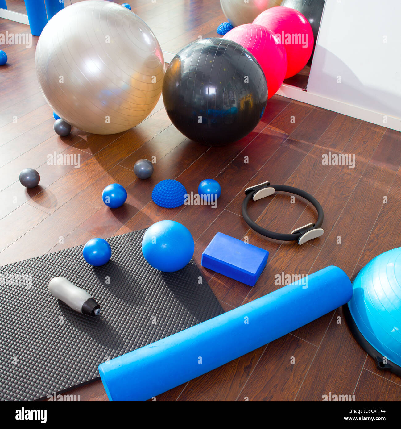 Aerobic Pilates stuff like mat balls roller magic ring rubber bands on wooden floor Stock Photo