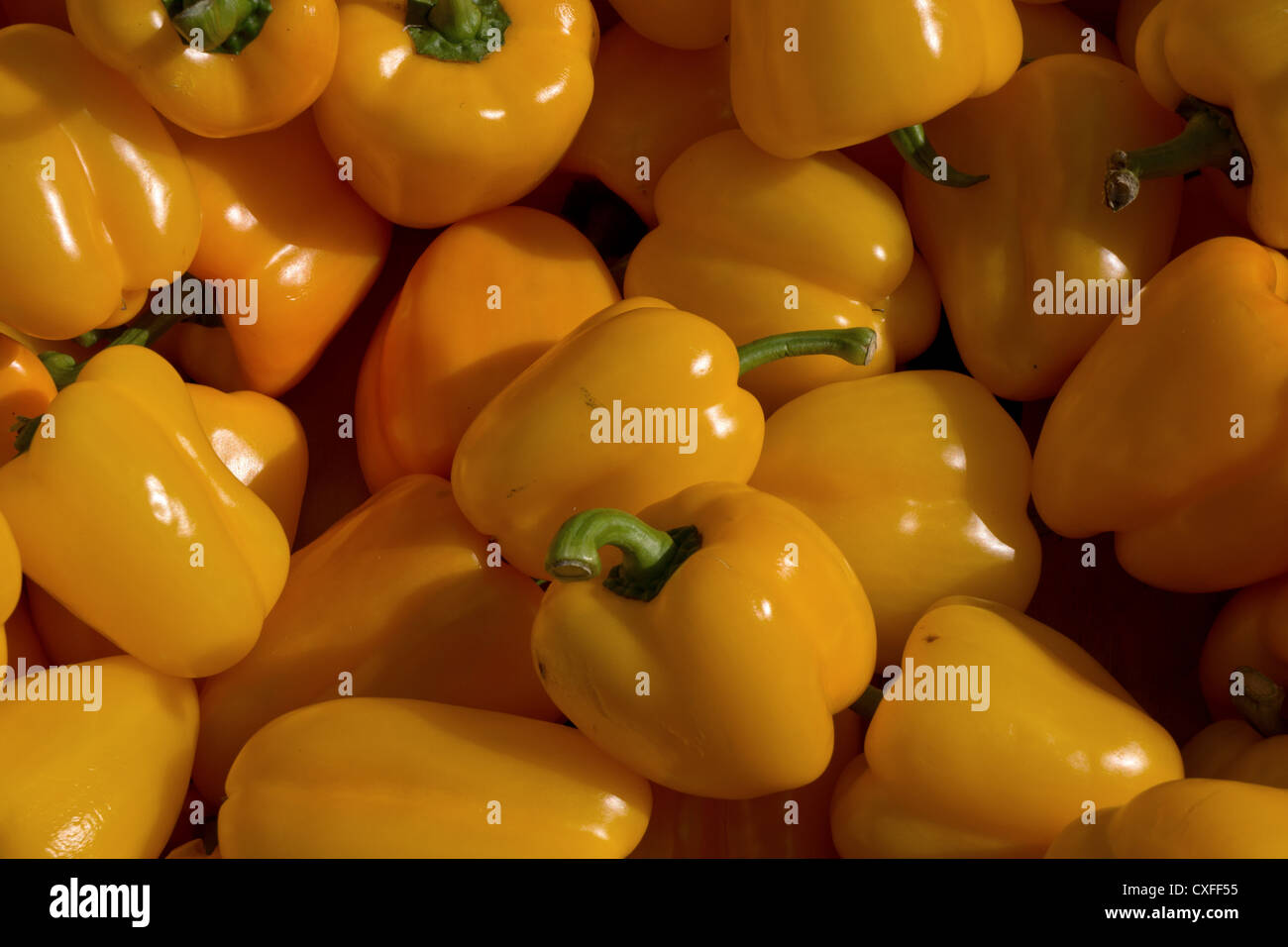 Bunch of yellow peppers on market stall Stock Photo - Alamy