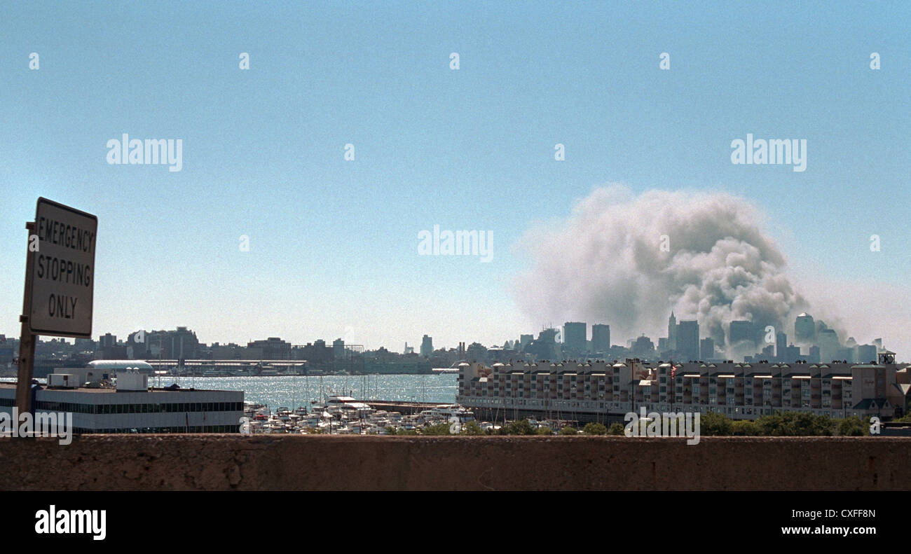 Smoke rises from the World Trade Center following terrorist attacks September 11, 2001 in New York City. Stock Photo