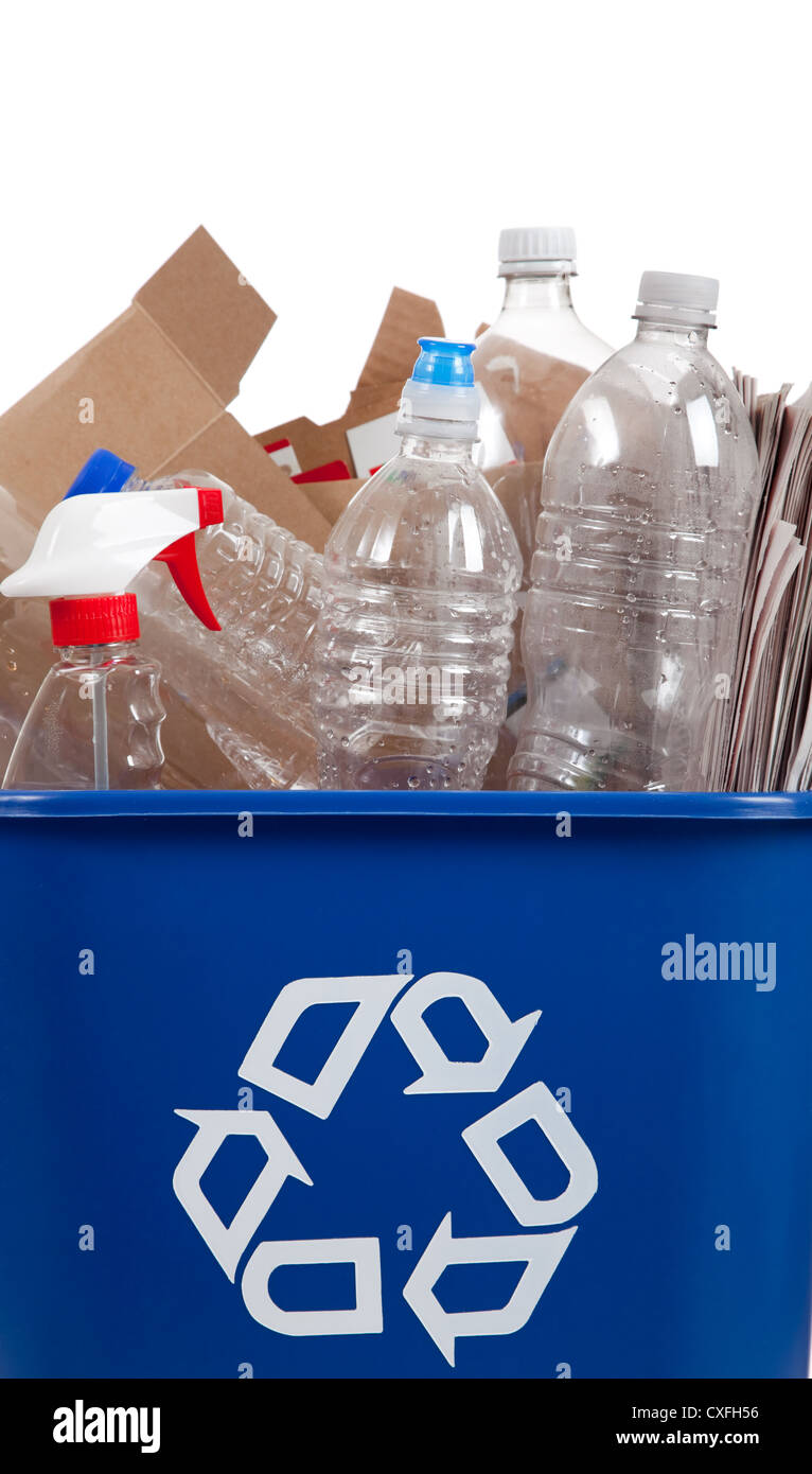 A blue recycle container full of plastic bottles and cardboard Stock Photo