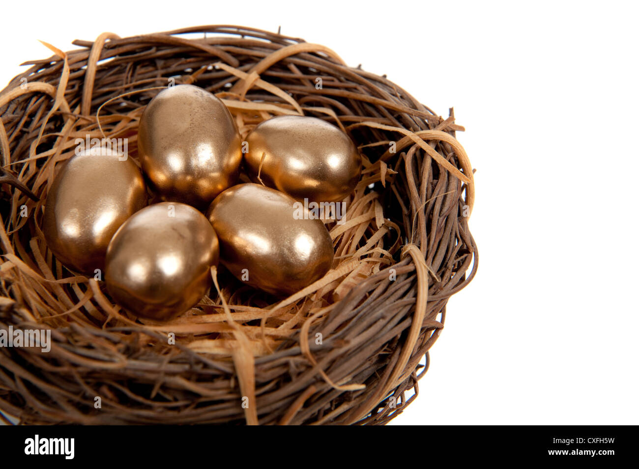 A nest of golden eggs on a white background Stock Photo - Alamy