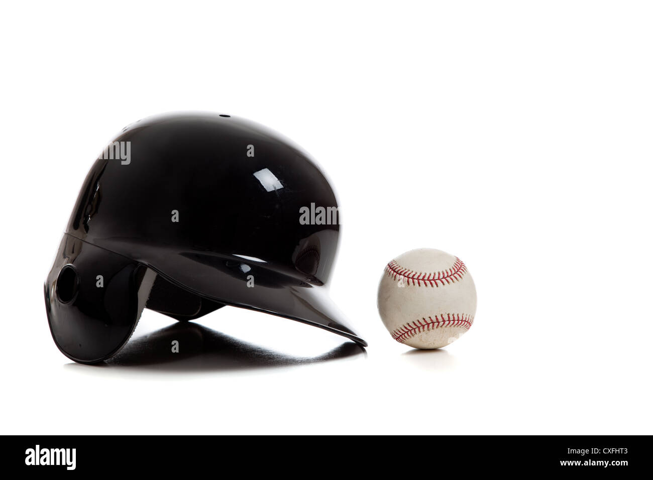 Black baseball batting helmet and ball on a white background Stock Photo