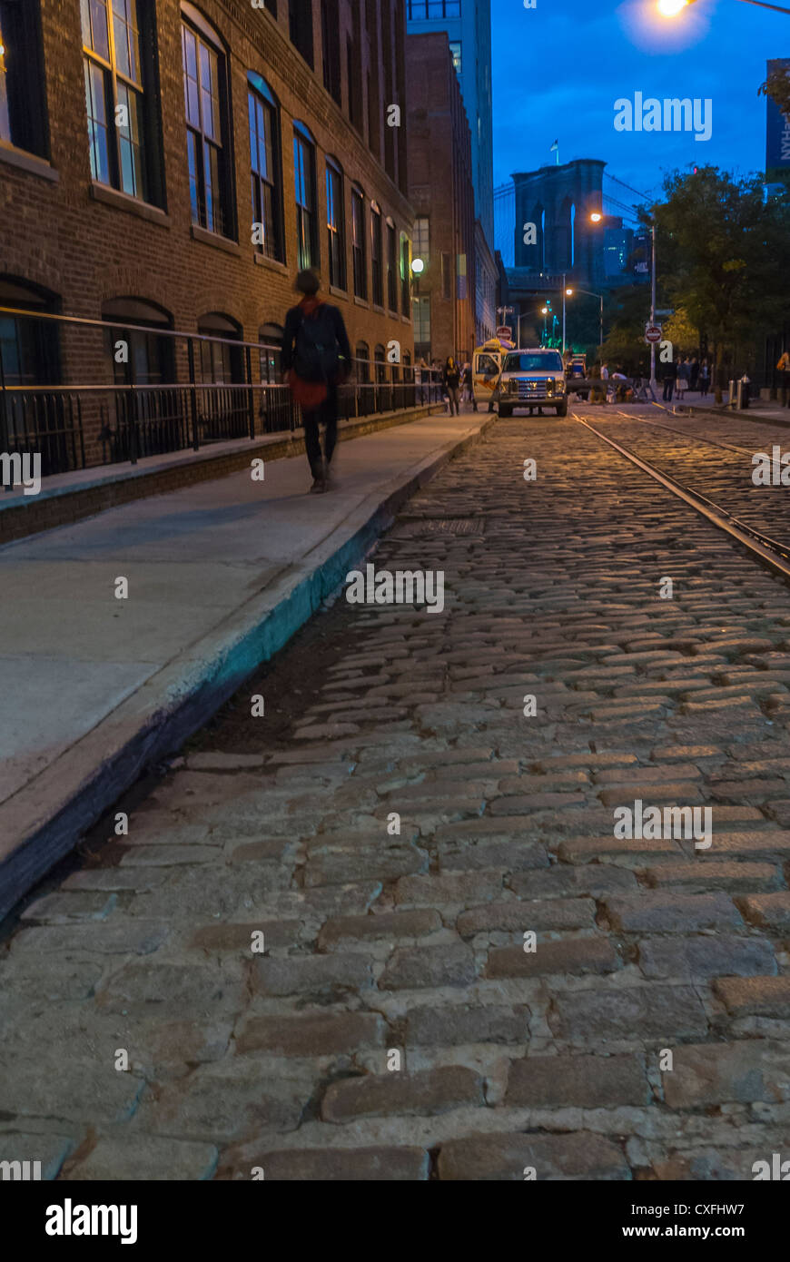 New York City, NY, USA, WOman Walking alone DUMBO Street Scene, Cobble Stone, at night, Brooklyn, Gentrification of city areas in US Stock Photo