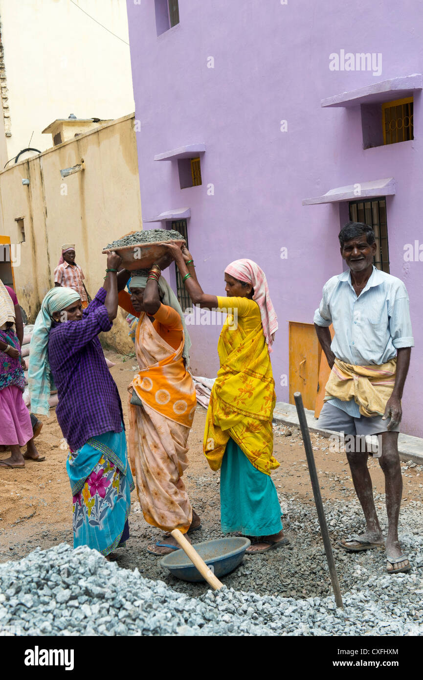 Indian men and women working on the roads in Puttaparthi, Andhra Pradesh, India. Stock Photo