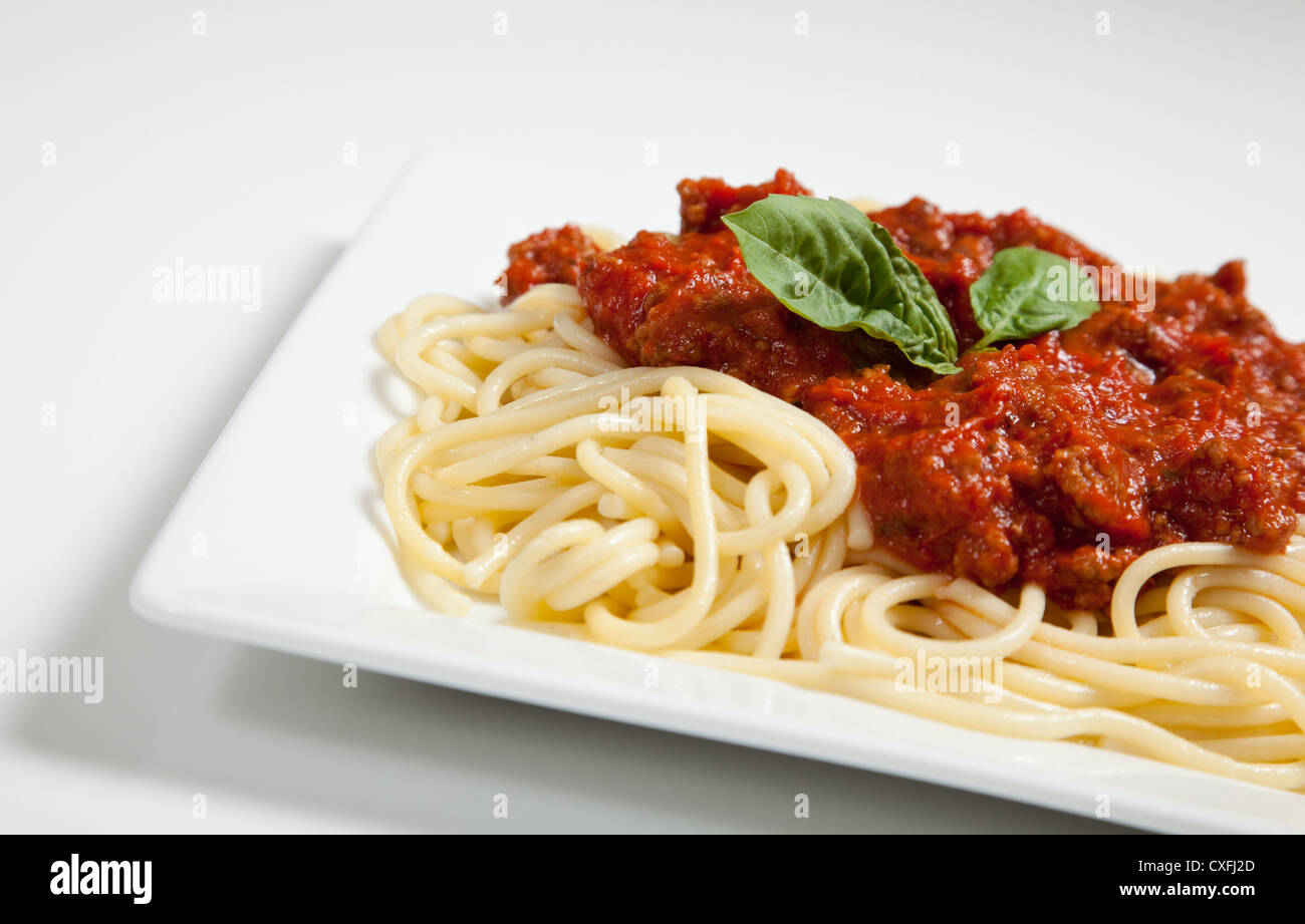 A Plate of spaghetti noodles with meat sauce on a white background Stock Photo Alamy