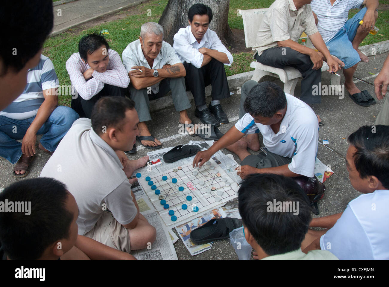 Men playing board game in street, Ho Chi Minh City, Saigon, Vietnam, SouthEast Asia Stock Photo