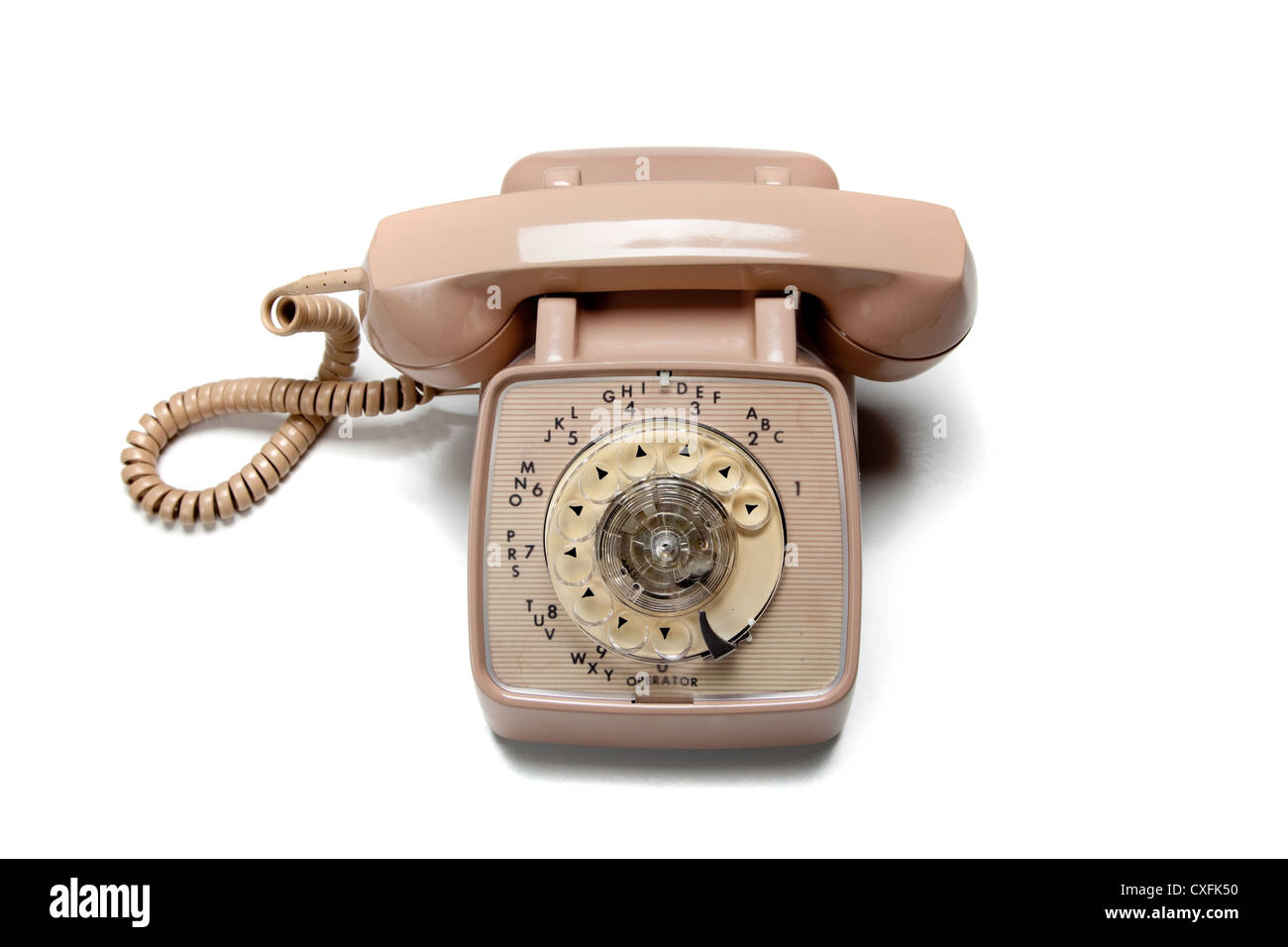 Vintage beige rotary phone on a white background Stock Photo