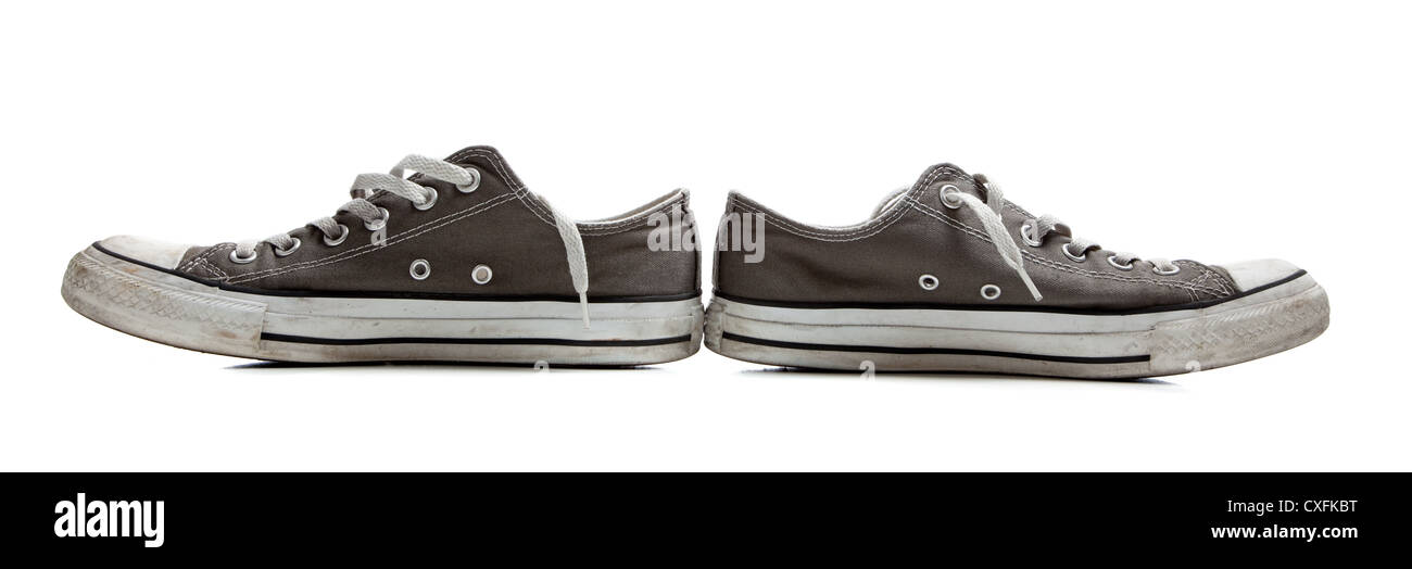Pair of old, retro gray sneakers on a white background Stock Photo