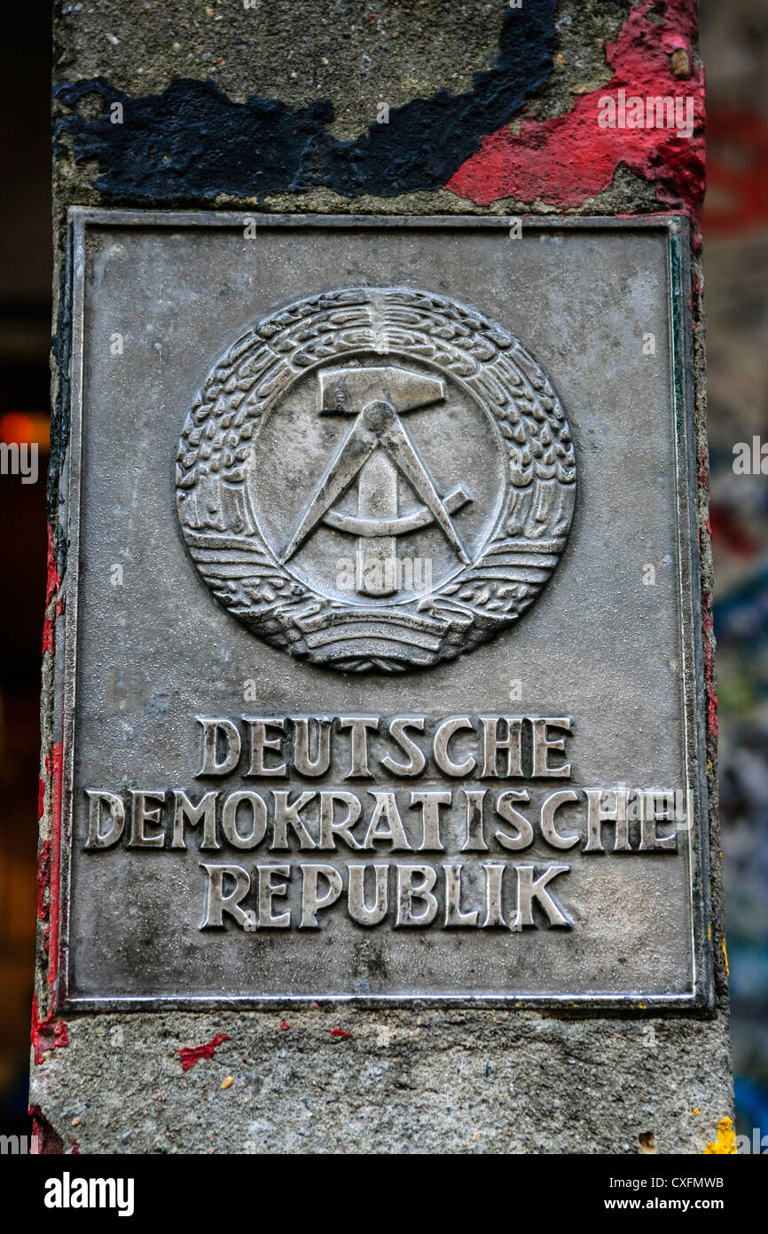 German Democratic Republic DDR Logo on display near Checkpoint Charlie in Berlin Stock Photo