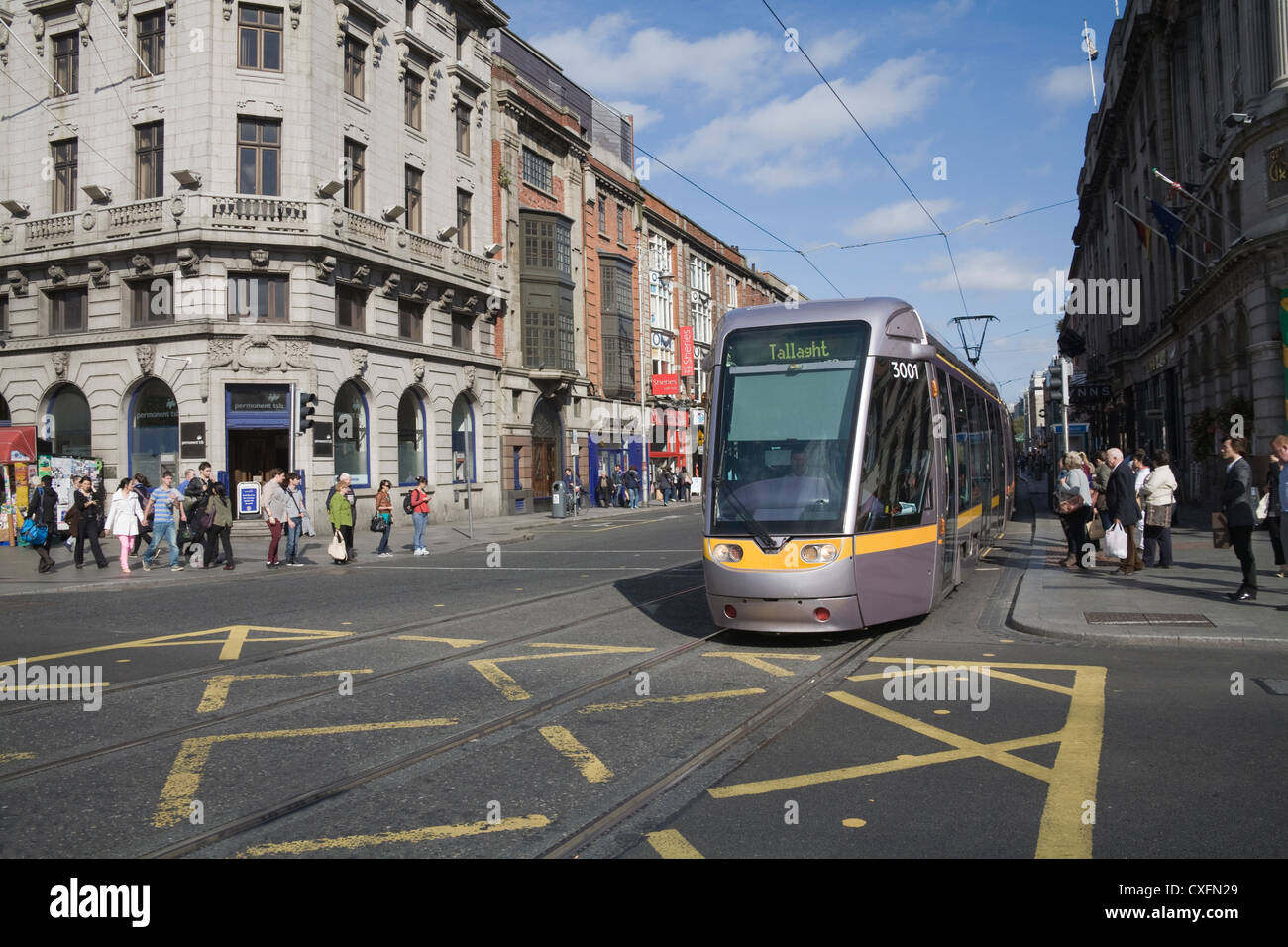 Dublin City Eire LUAS light transport tram crossing O'Connell Street busy wide main street of this capital city Stock Photo