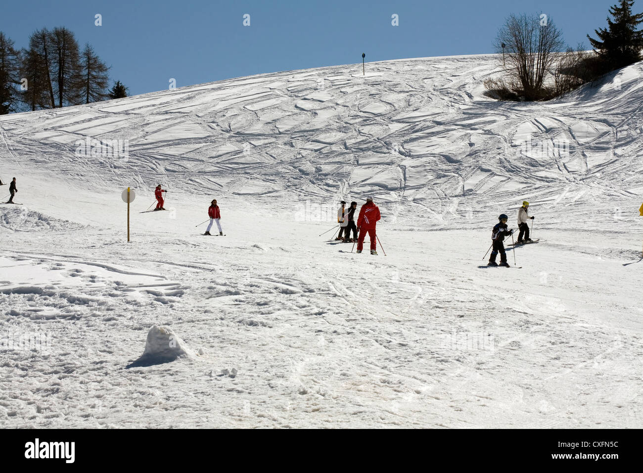 Children learning to ski at ski school on the pistes at Alpe Di Siusi Seiser Alm Val Gardena  Dolomites Italy Stock Photo