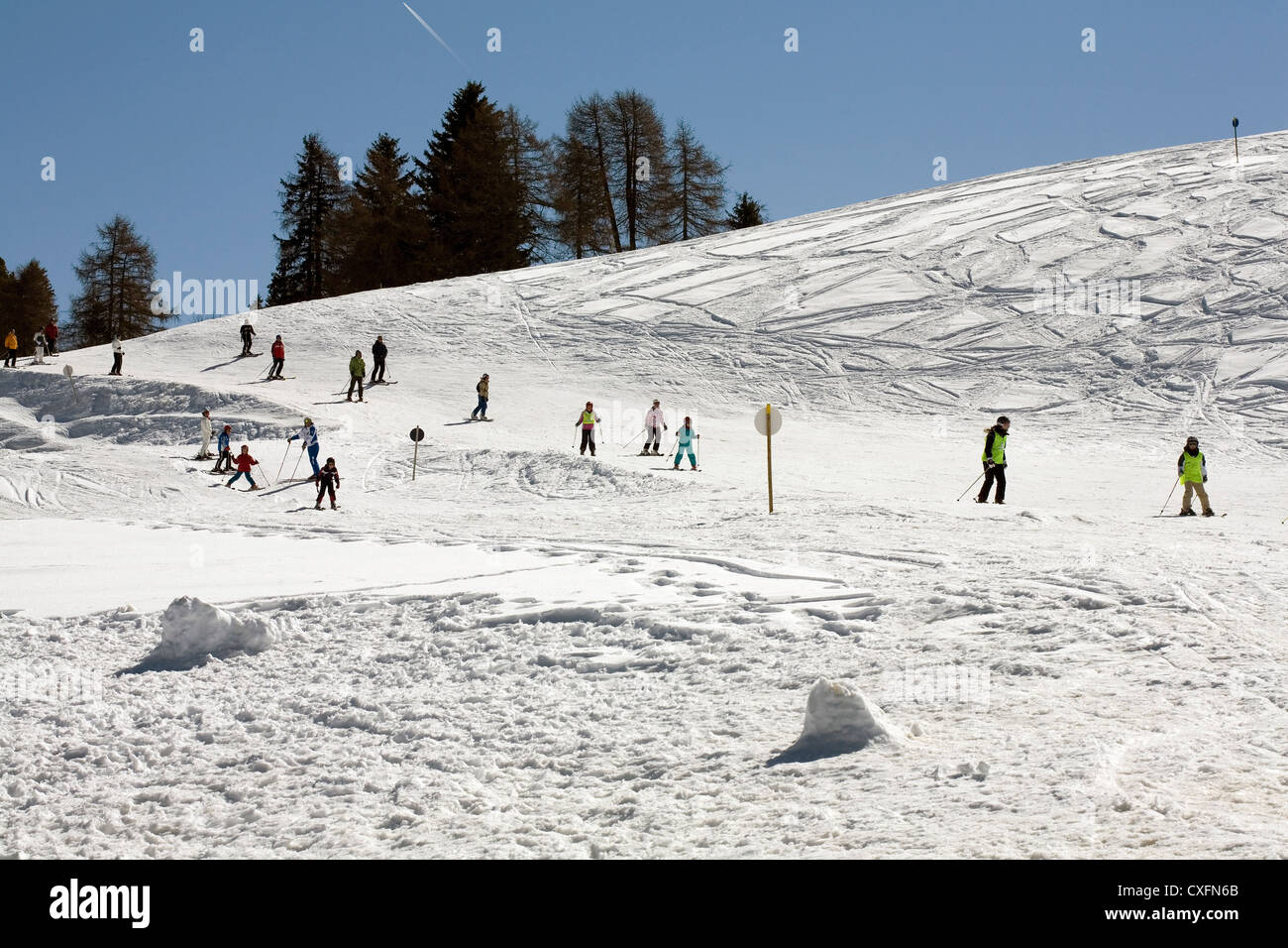 Children learning to ski at ski school on the pistes at Alpe Di Siusi Seiser Alm Val Gardena  Dolomites Italy Stock Photo