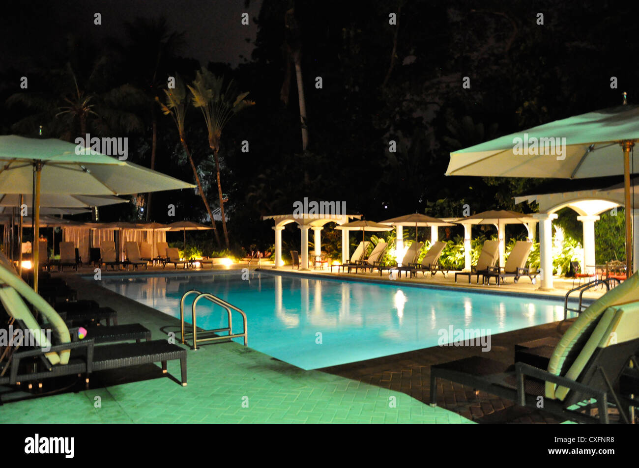 Royal Pavilion Barbados pool area at night Stock Photo