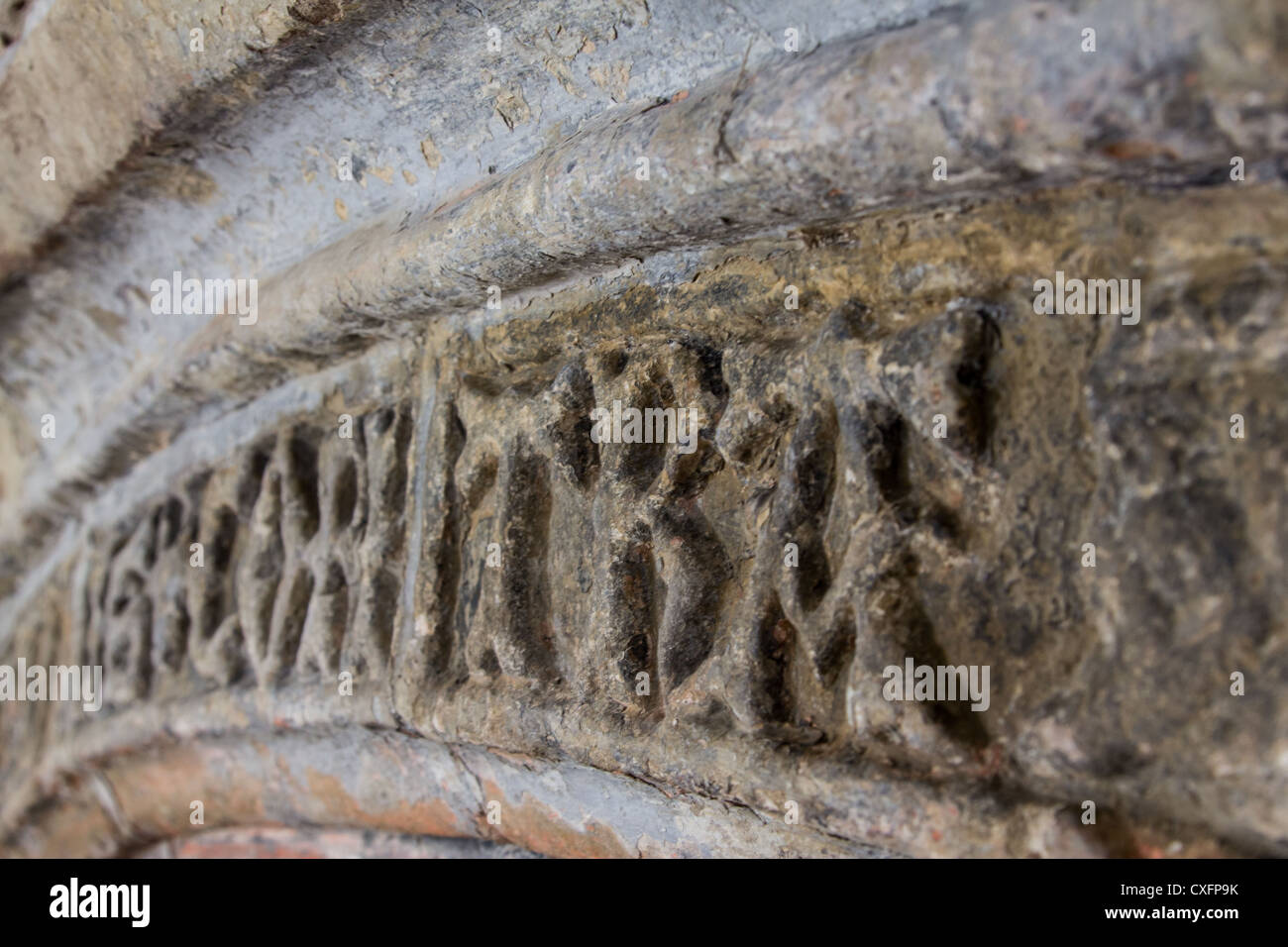 Latin stone inscription above fireplace at the medieval Welsh hall house, Neuadd Hafoty, Isle of Anglesey. Stock Photo