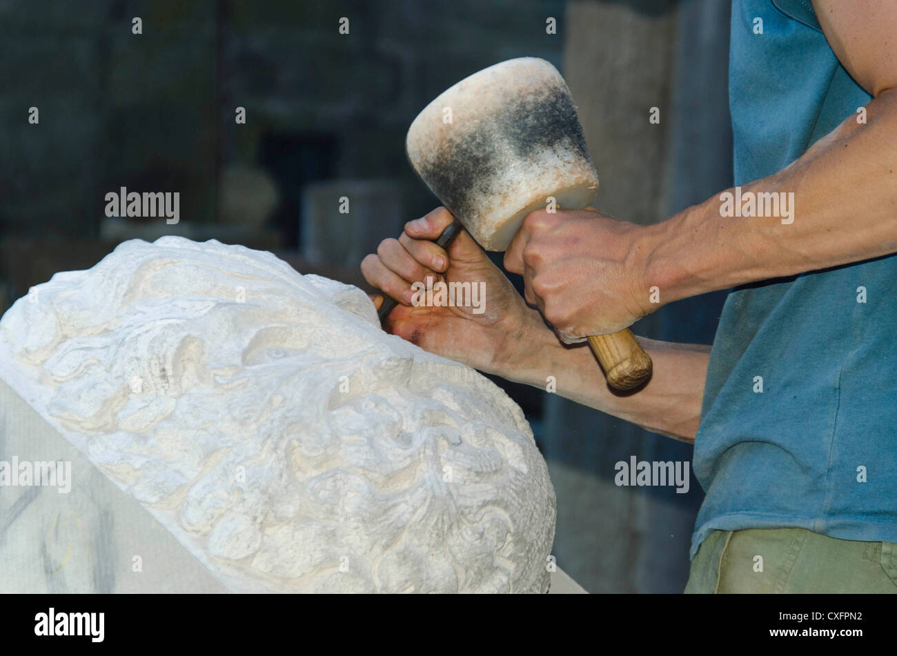 A stone mason at work on the restoration being carried out on Hereford