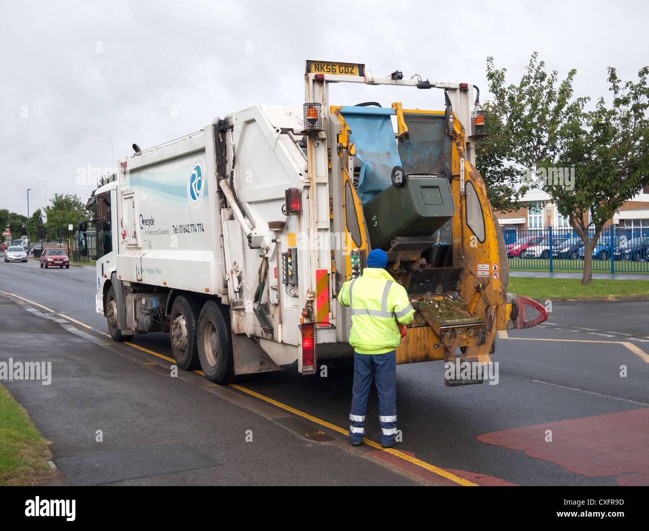 A waste disposal vehicle collecting green garden waste for recycling