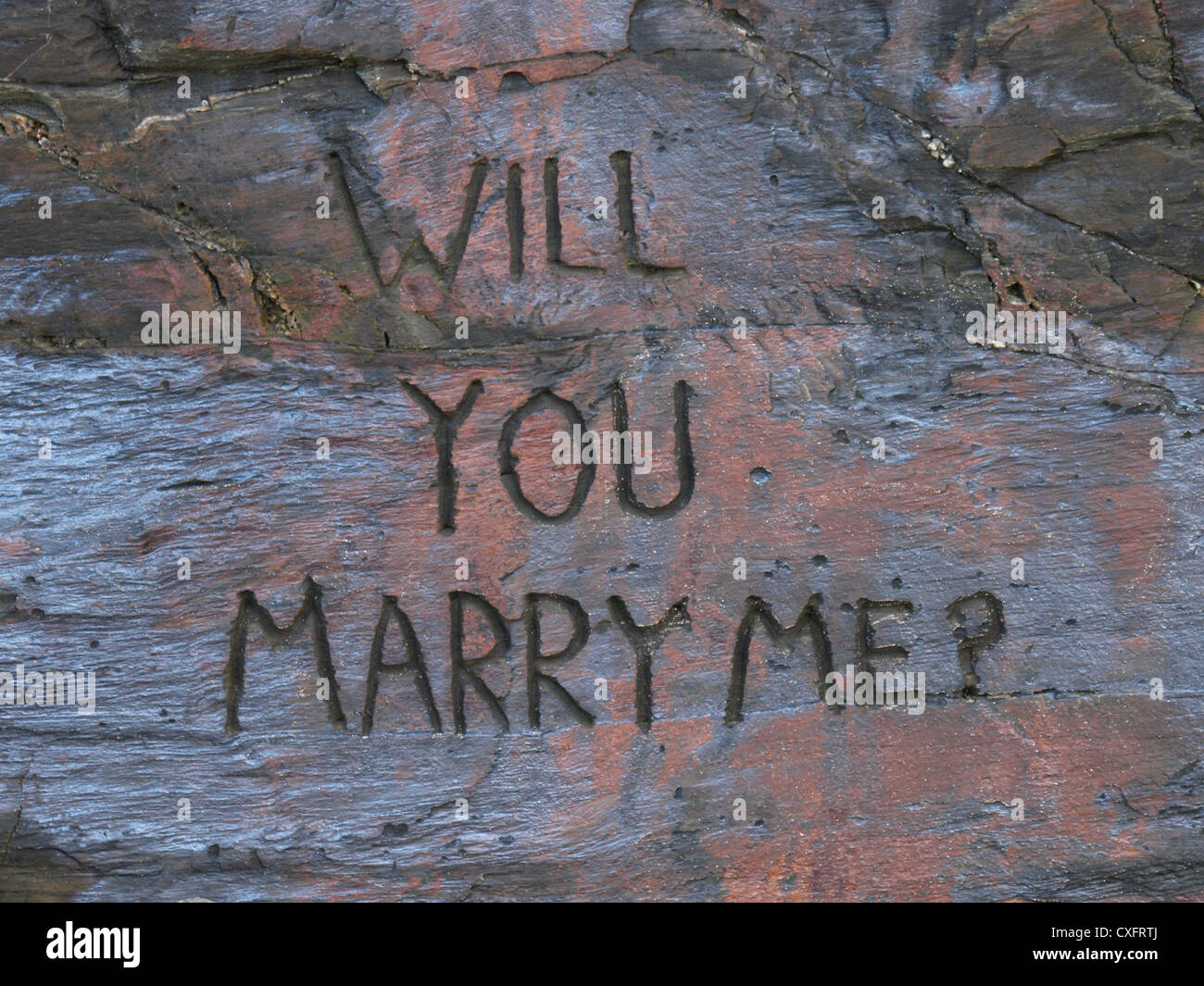 Will you marry me carved into the rock, Watergate Bay, Cornwall, UK Stock Photo