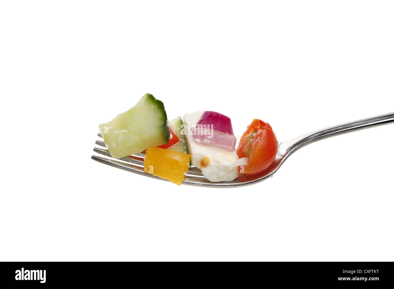 Greek salad on a fork isolated against white Stock Photo