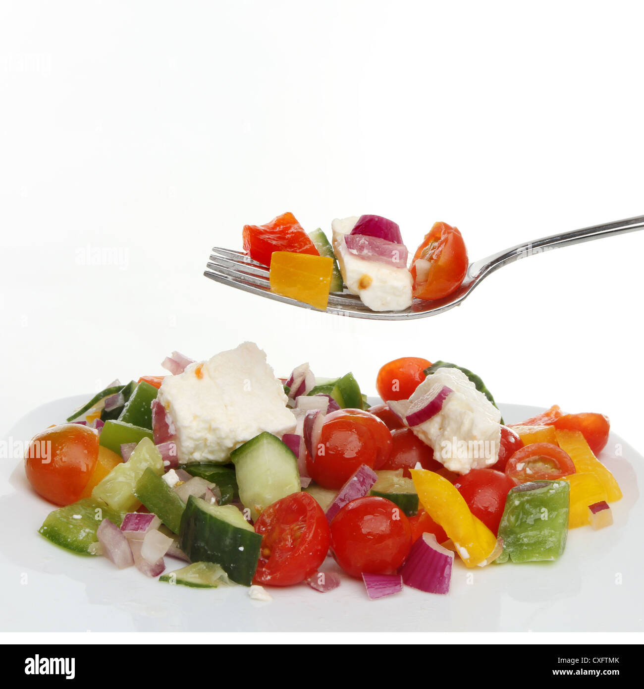 Closeup of a Greek salad on a plate and a fork Stock Photo
