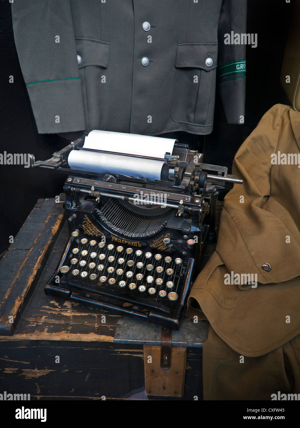 Old fashioned Russian typewriter with military uniforms displayed Stock Photo
