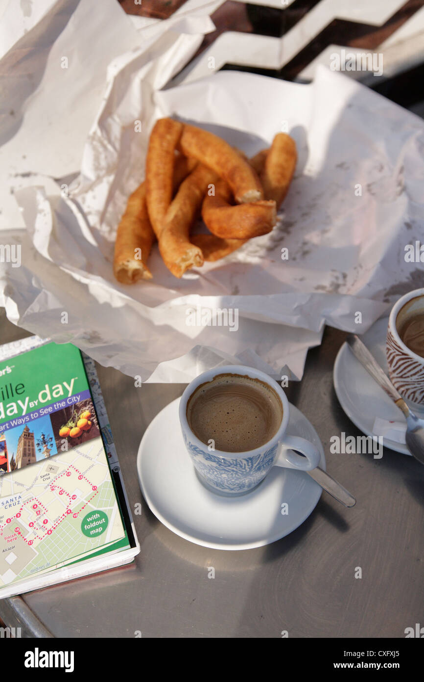 Churros coffees and a Seville guidebook ,tourist's mid morning snack Stock Photo