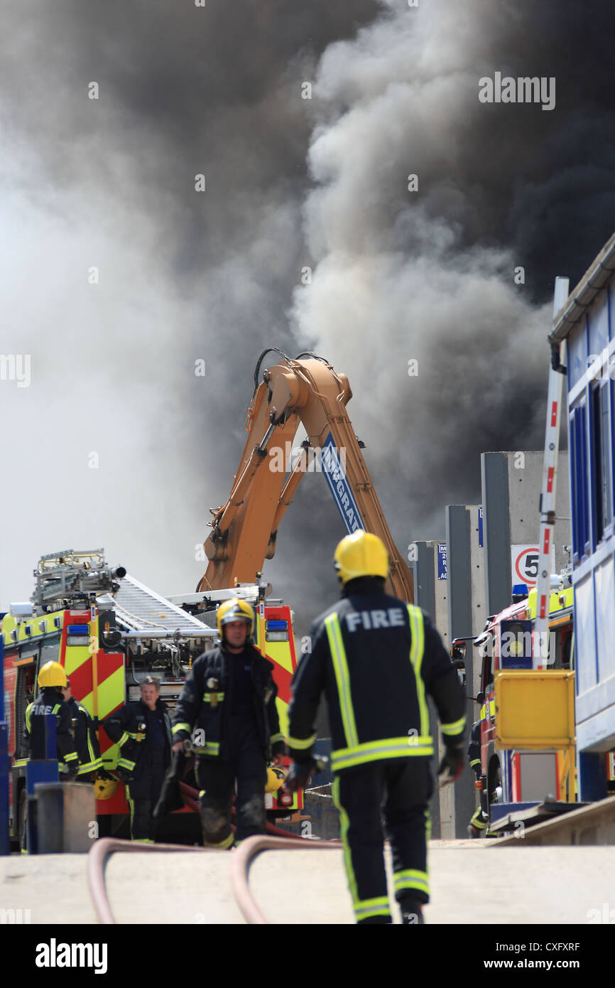 Firefighters at the scene of a fire in a recycling plant in London ...