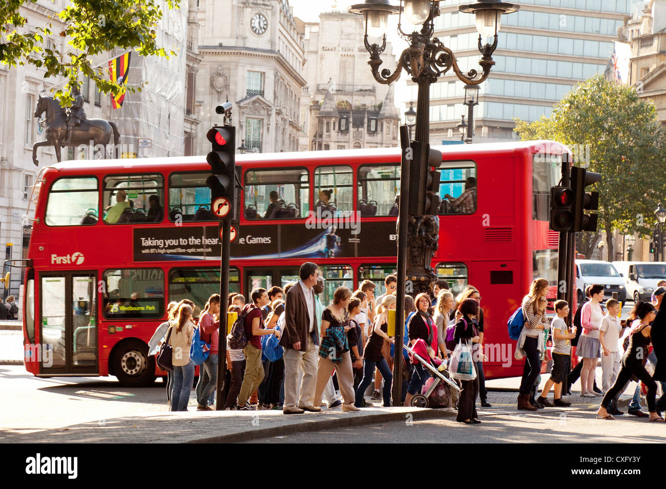 Street scene with red bus and people, Trafalgar Square London city centre, London, England UK Stock Photo