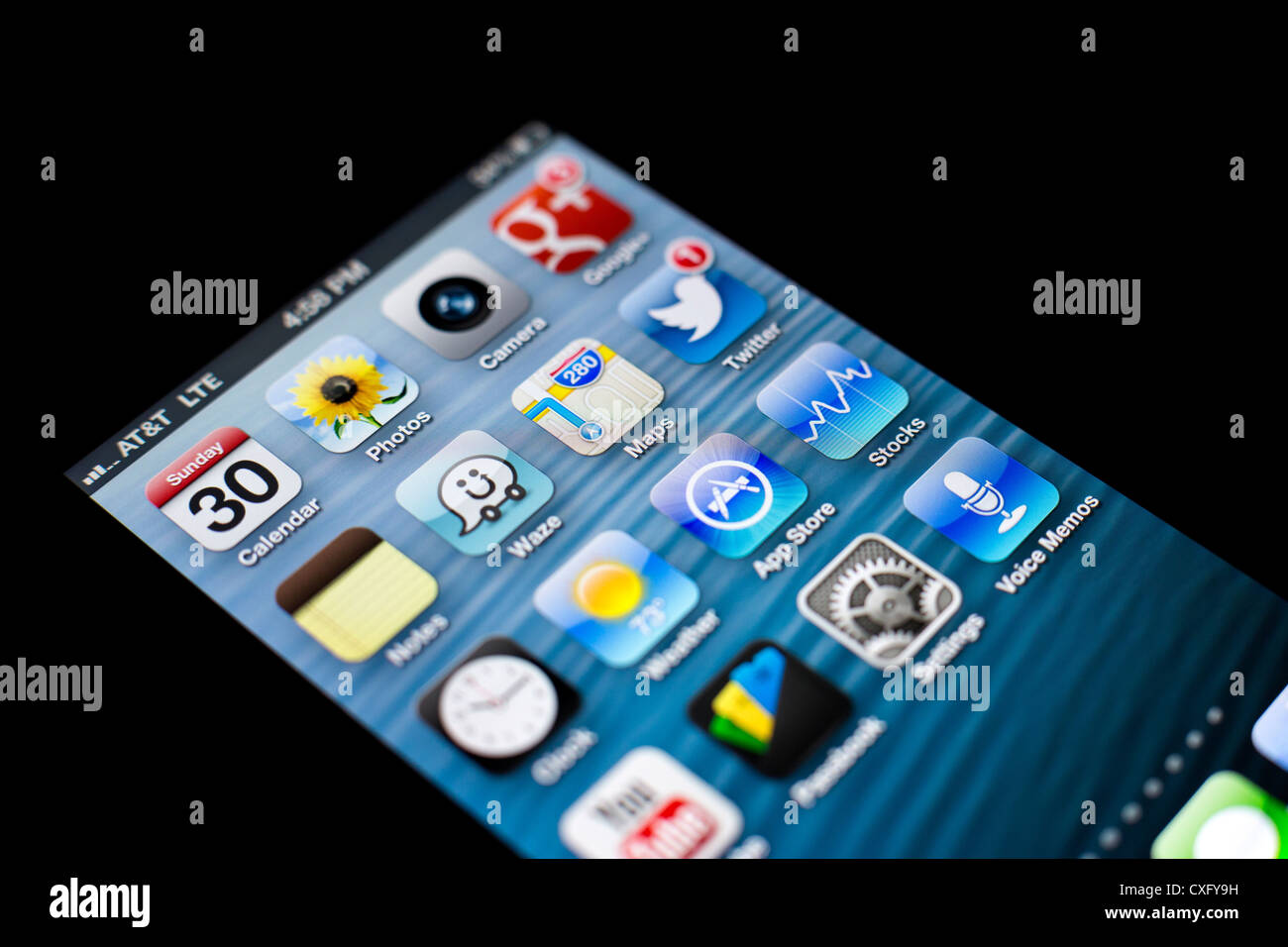 Screen of the new iPhone 5 showing new Maps app and other various apps: Passbook, Twitter, App Store, Clock, Wuze, YouTube, G+ Stock Photo