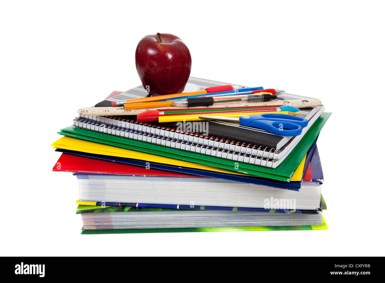 Stack of school supplies with an apple on top Stock Photo