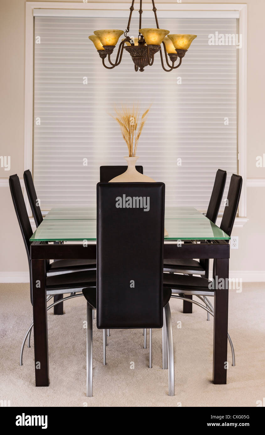 Modern Dining Room with glass top table, leather chairs, chandelier and