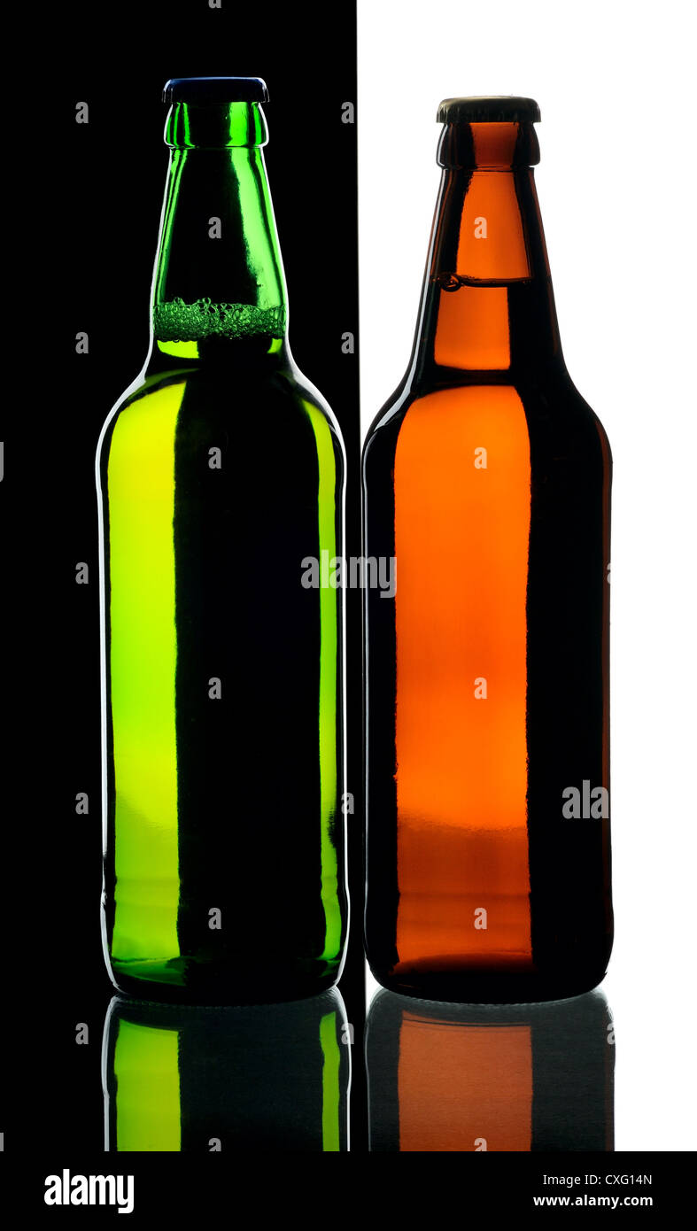 Bottles of lager beer from green and brown glass, isolated on a black and white background. Stock Photo