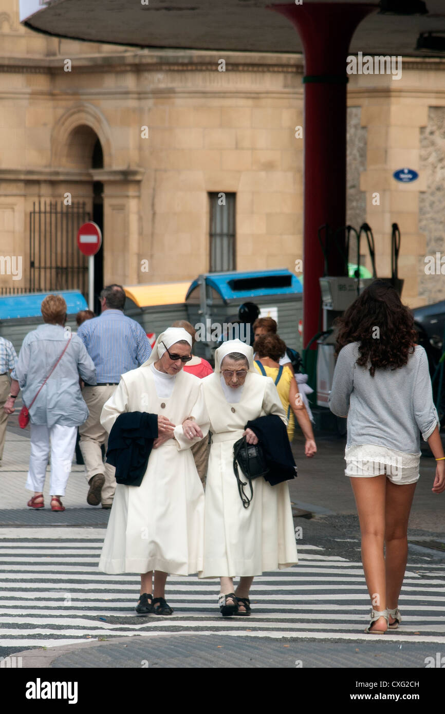 Two nuns in traditional dress cross a road in San Sebastian northern Spain Stock Photo