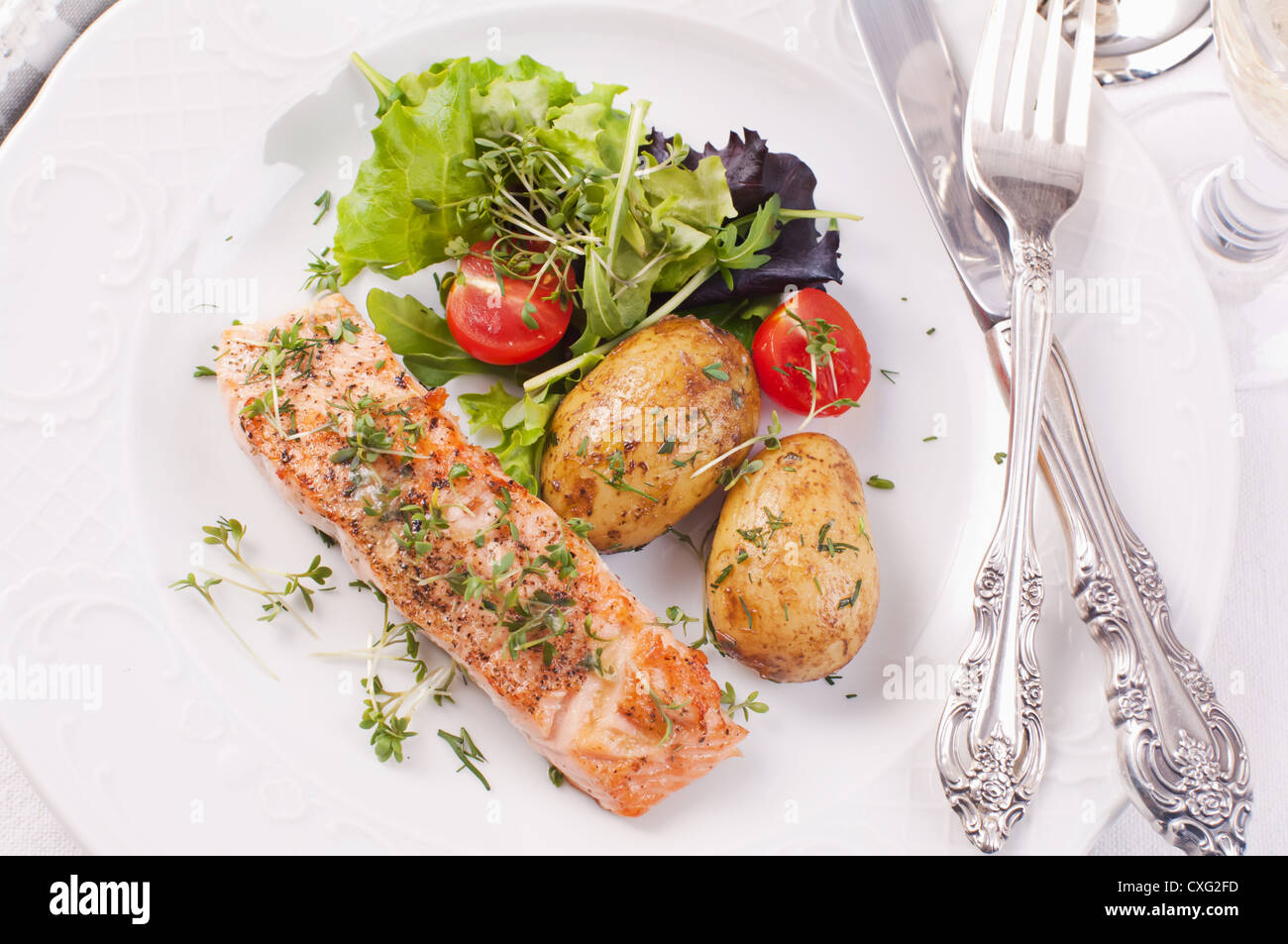 salmon steak grilled with potato and salad Stock Photo - Alamy