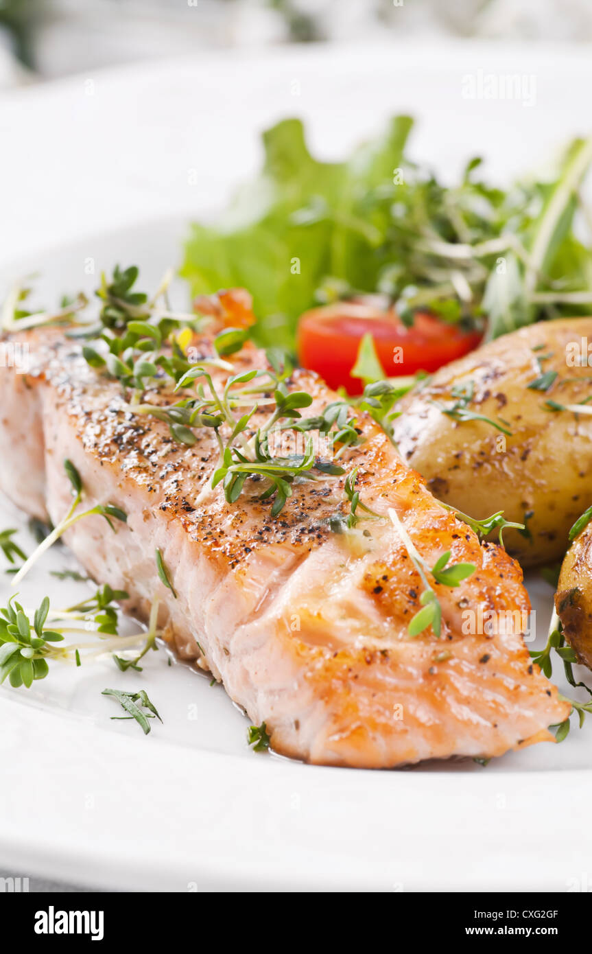 Salmon steak roasted with Salad and potato Stock Photo - Alamy
