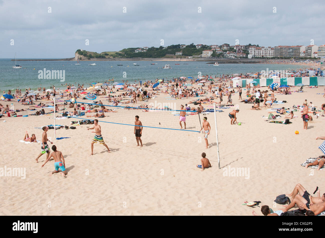 Holidaymakers playing volleyball on the beach at St Jean de Luz