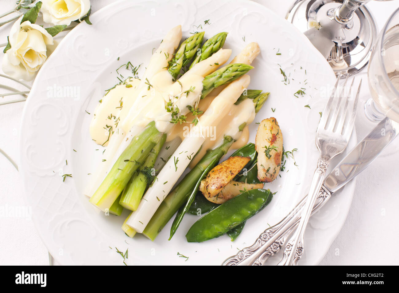 Asparagus with potato and sugar snaps Stock Photo