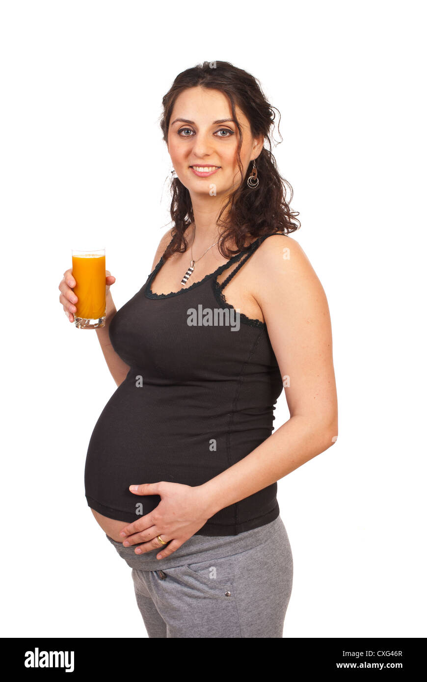 Pregnant woman holding orange juice isolated on white background Stock ...