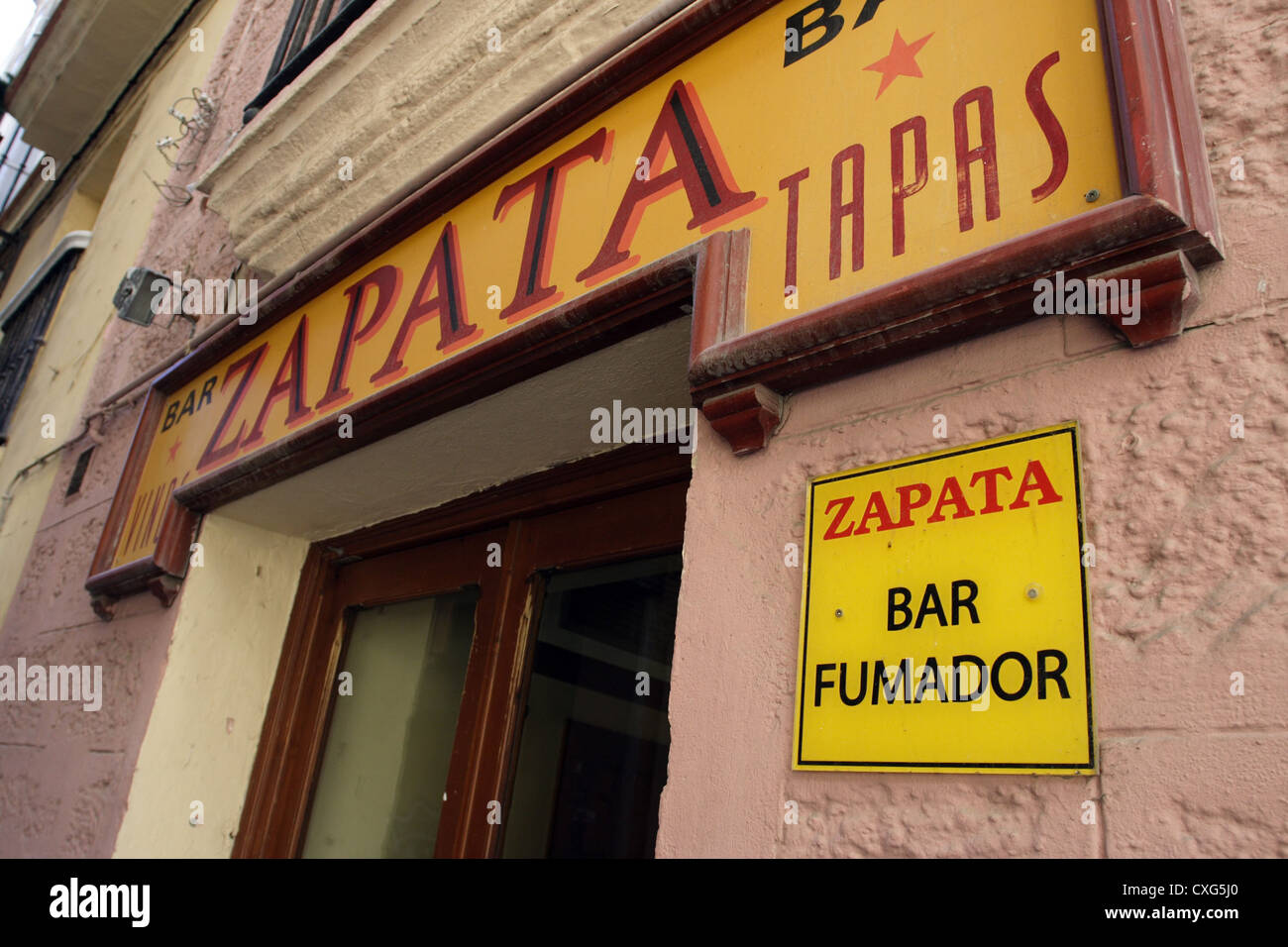 Cadiz, a tapas bar in front of me smoking labeling Stock Photo