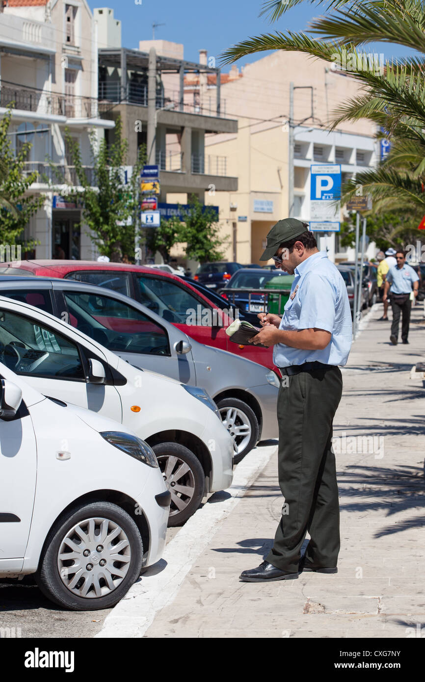 Traffic warden issuing parking ticket to 'Rental Car'. Argostoli Cephalonia Greece Stock Photo