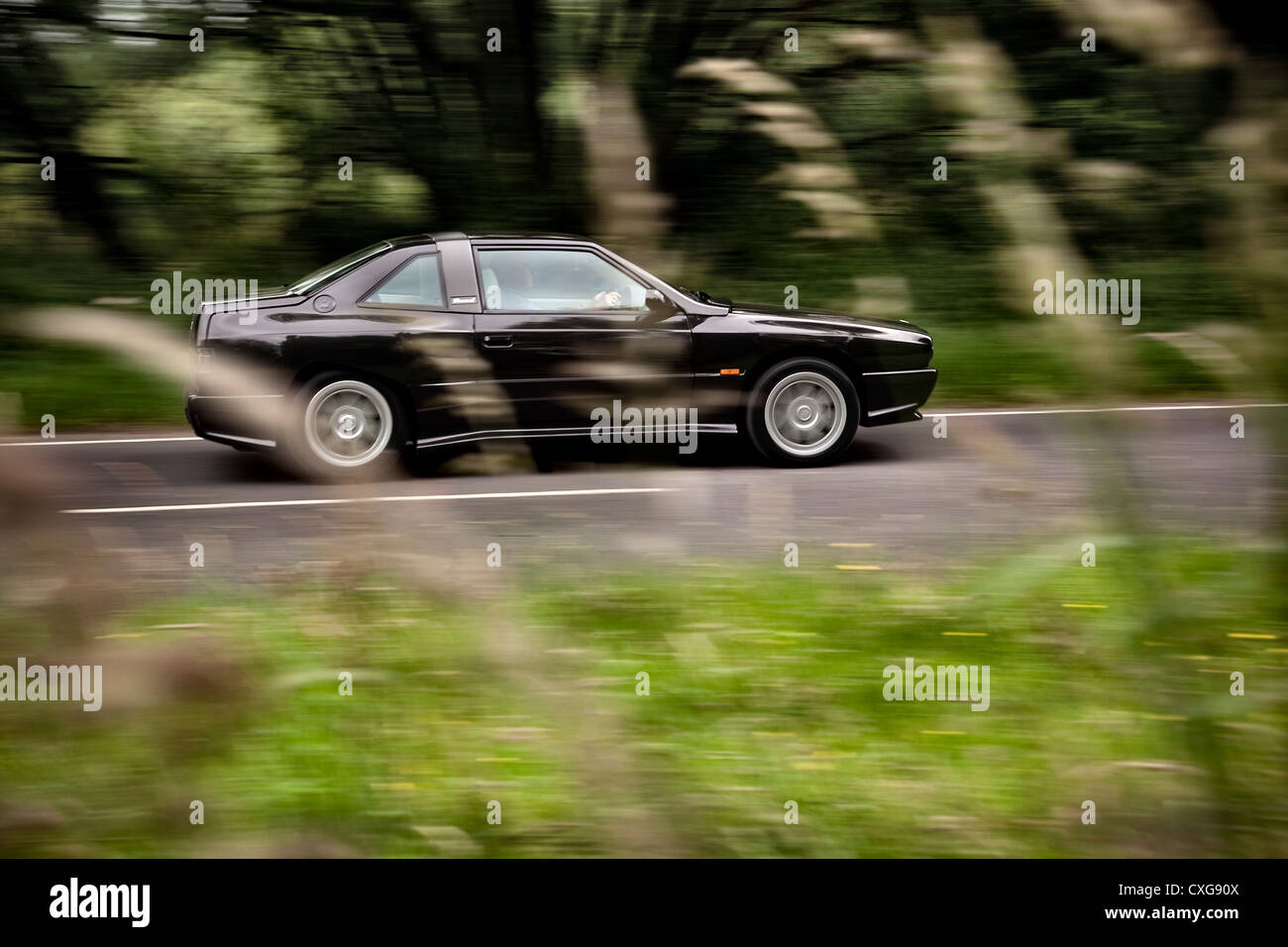 Maserati Shamal 1991 driving on a country road in the UK Stock Photo