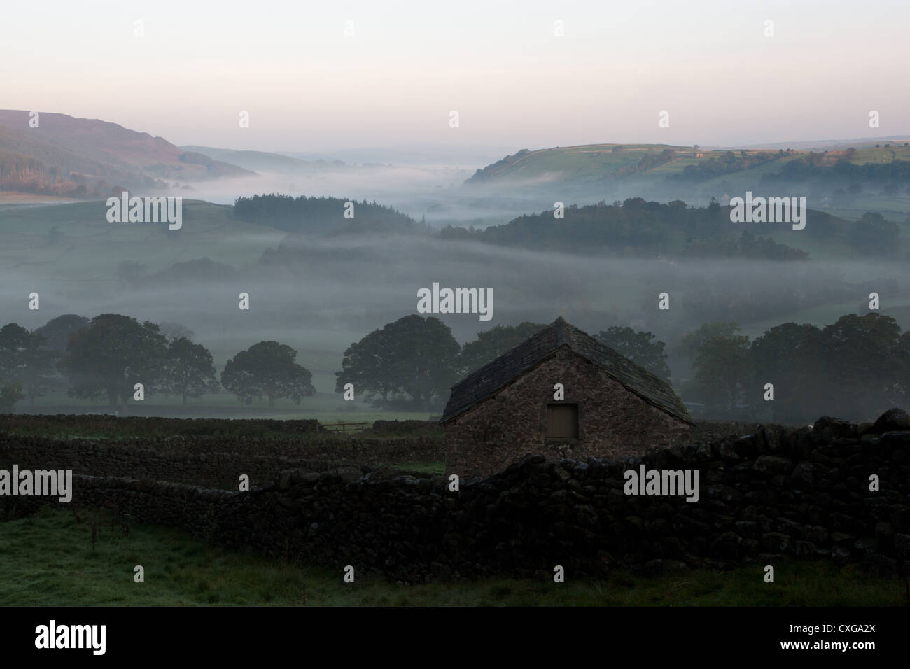 Barn in early morning mist  Wharfedale , Yorkshire Dales, Stock Photo