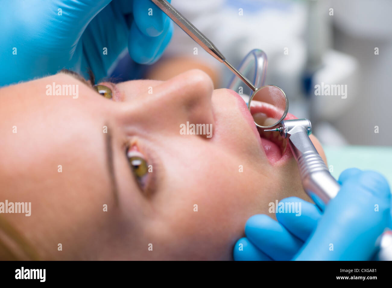 Dental treatment close-up female patient mouth with medical tools Stock Photo