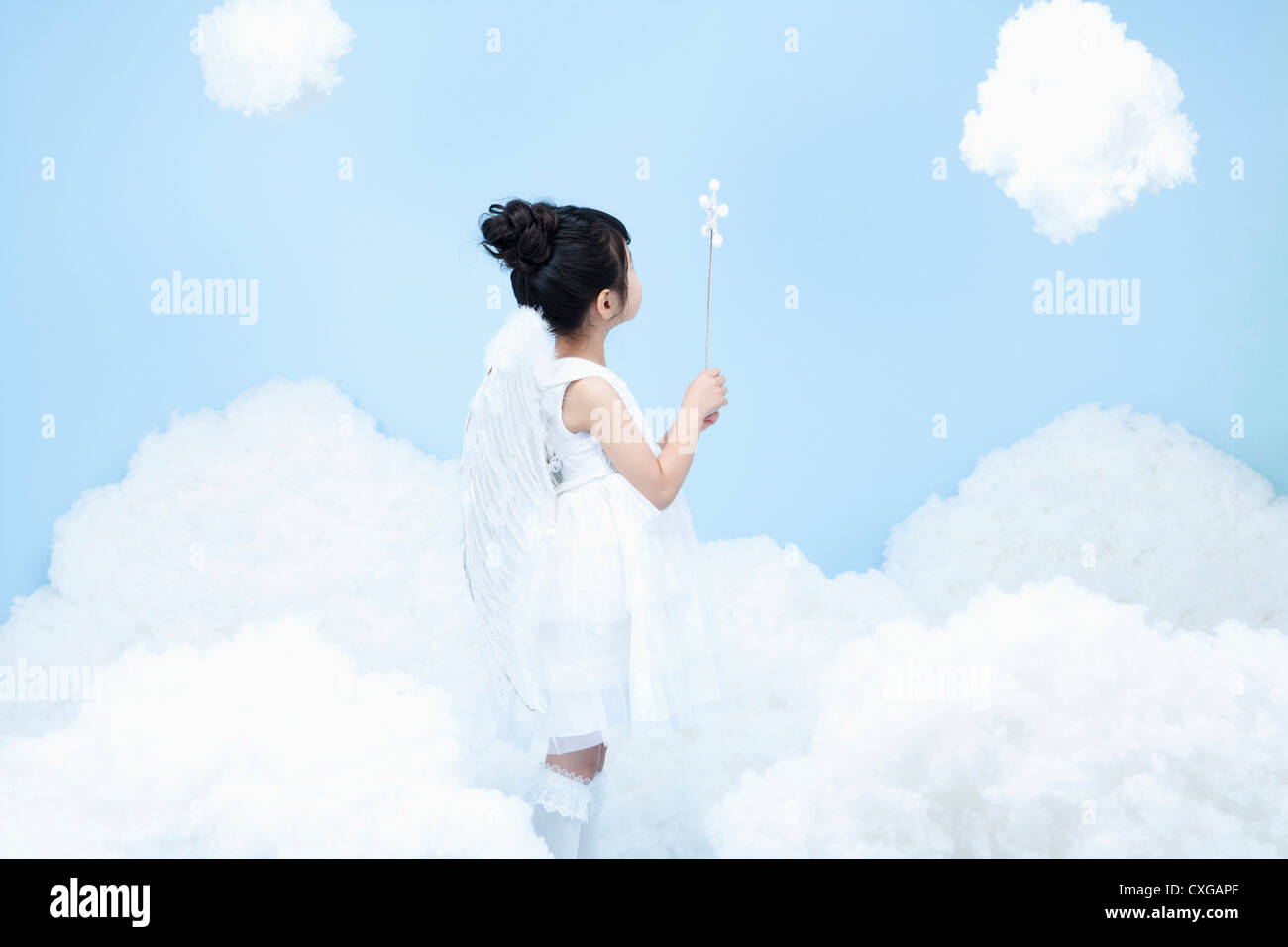 little girl with looks of angel on the clouds Stock Photo - Alamy