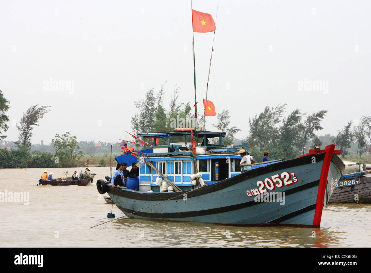 Vietnam, Vietnamese fishing boat with waving flags on the mast